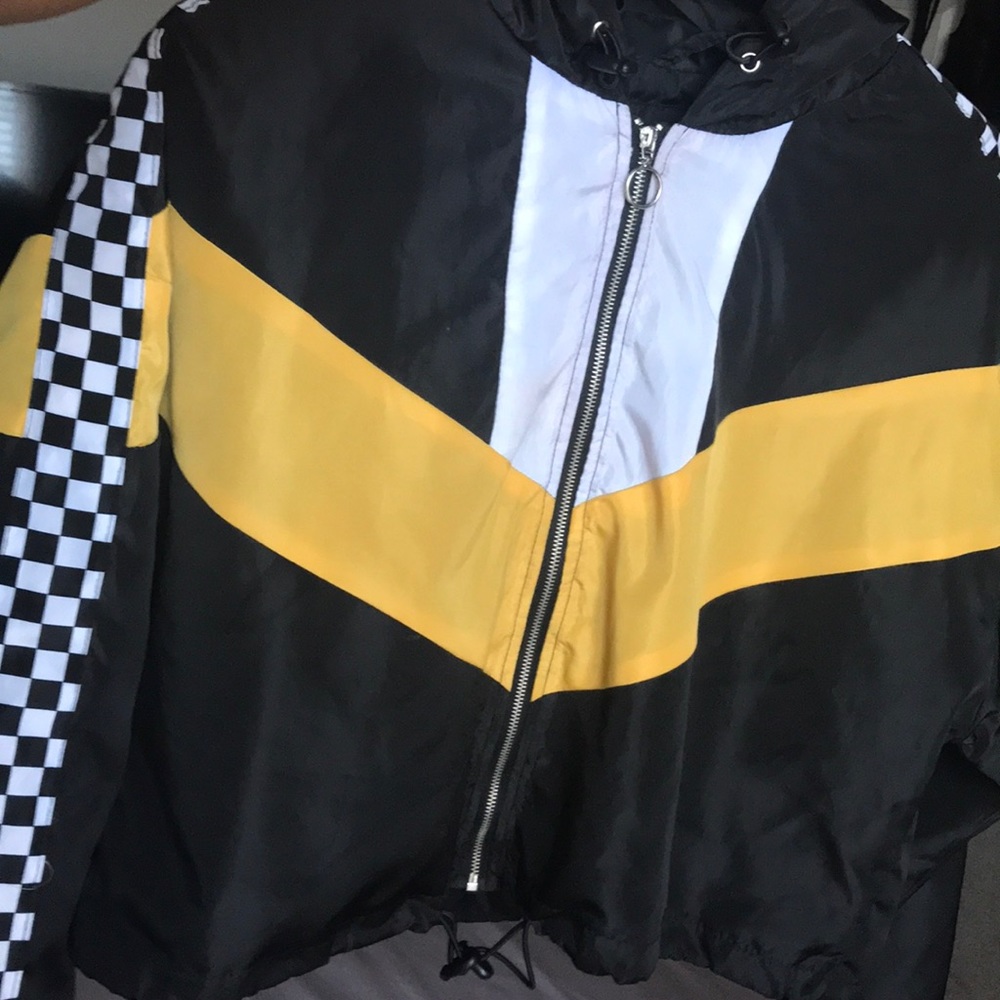 Yellow black and white checkerboard windbreaker.